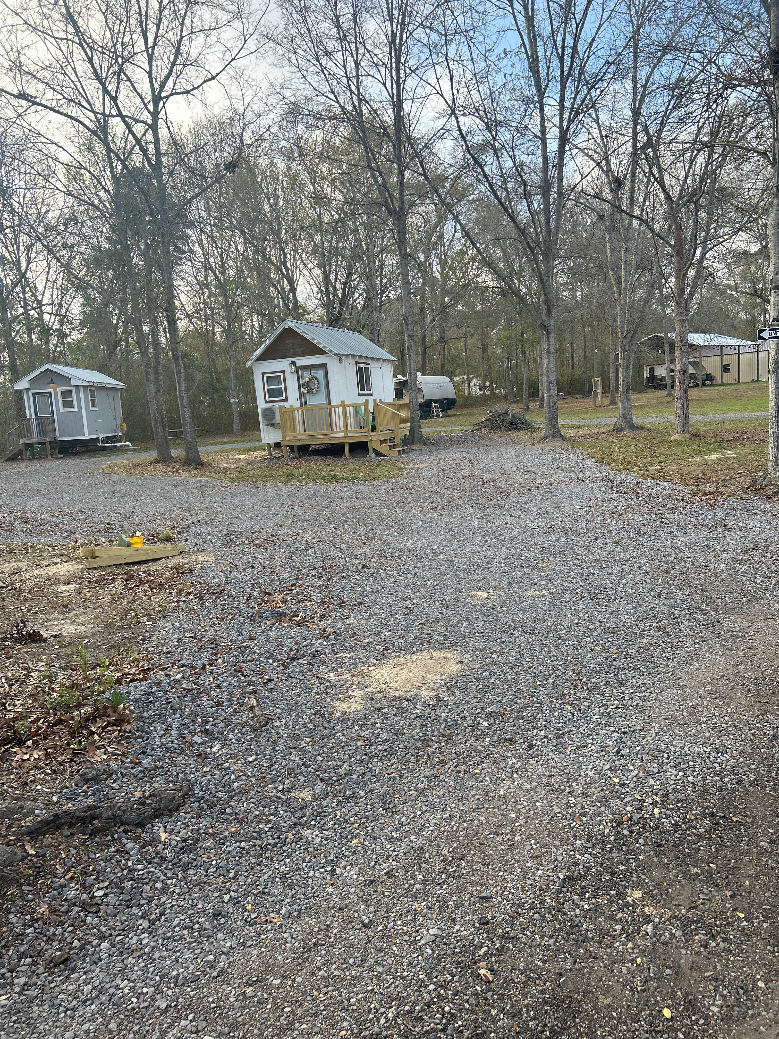 Left turn to gravel one-way loop. Pass 2 tiny homes to 2 RV sites on west side of property