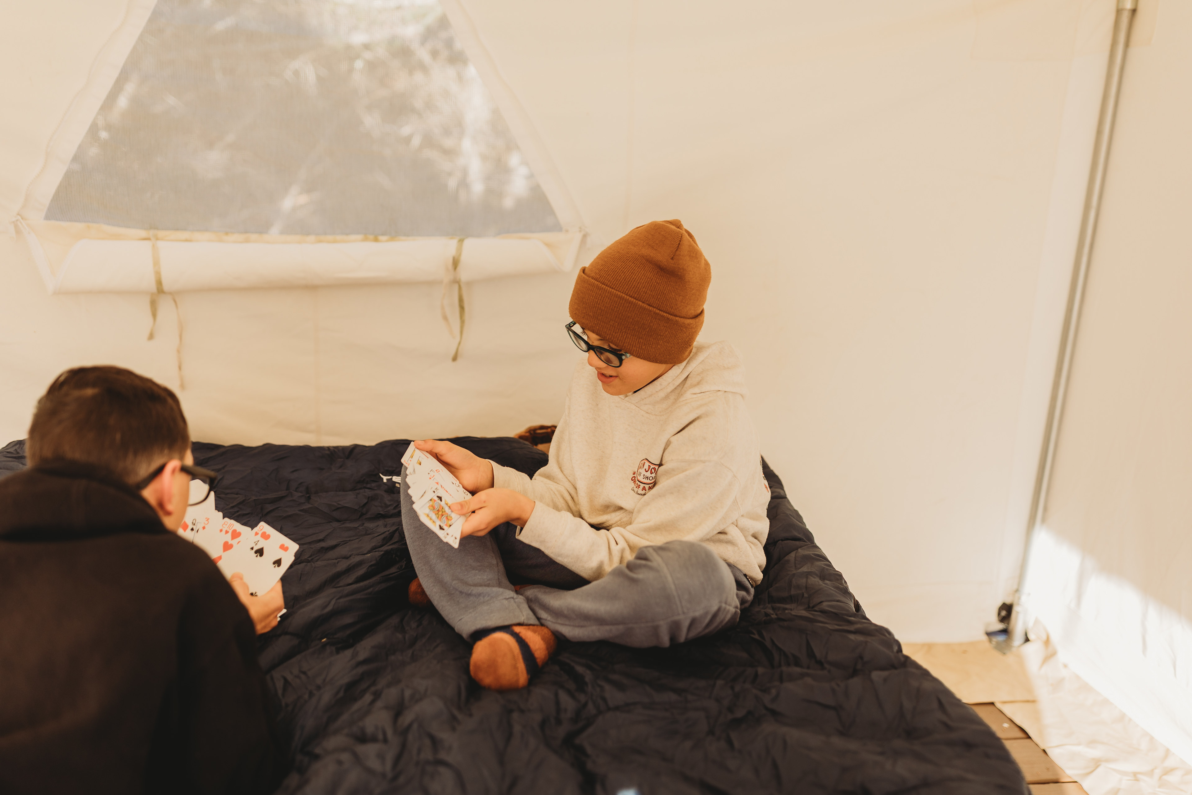 Playing cards inside the glamping tent. The mattress was very comfortable!
