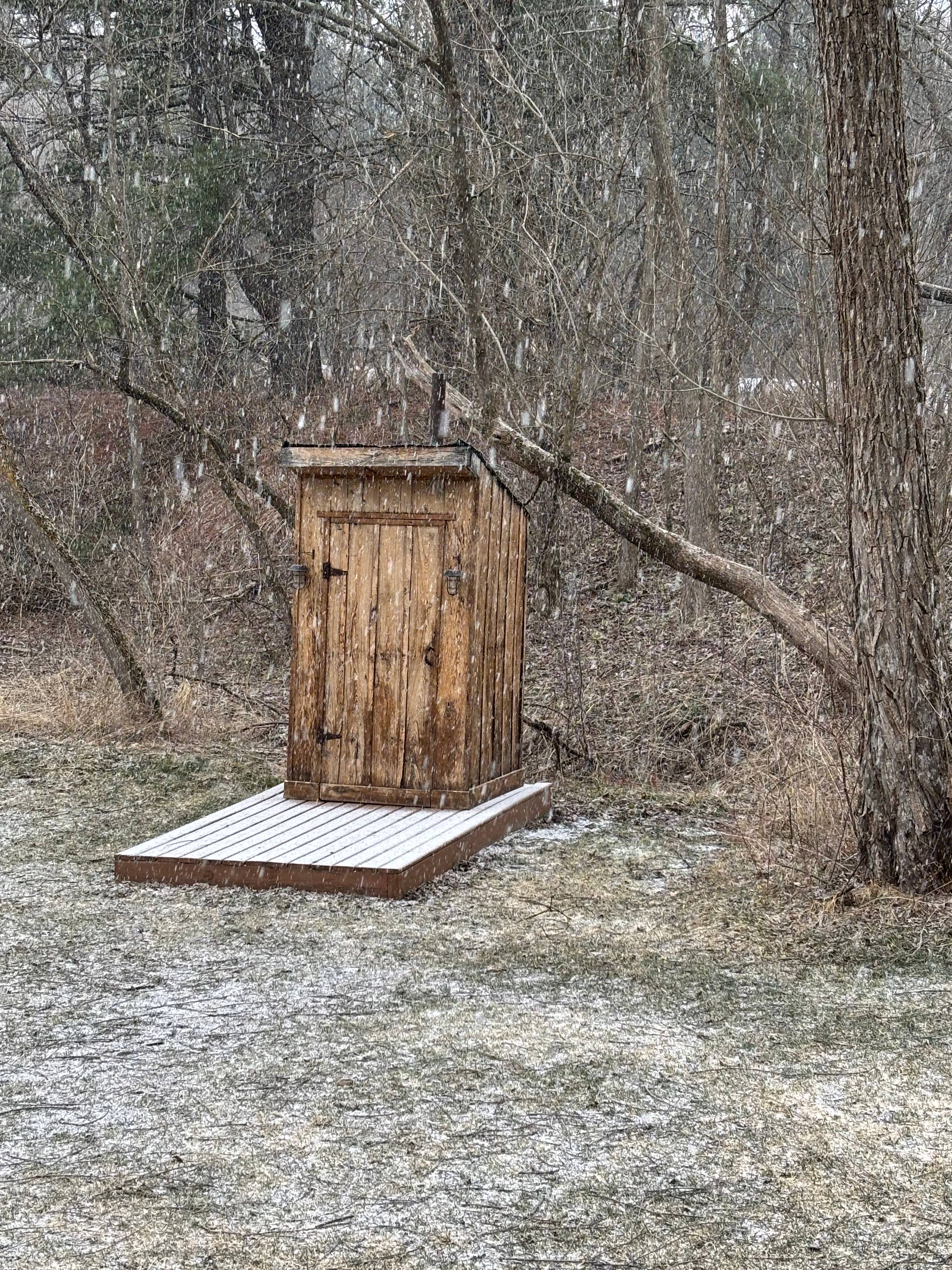 Snowing on the outhouse 