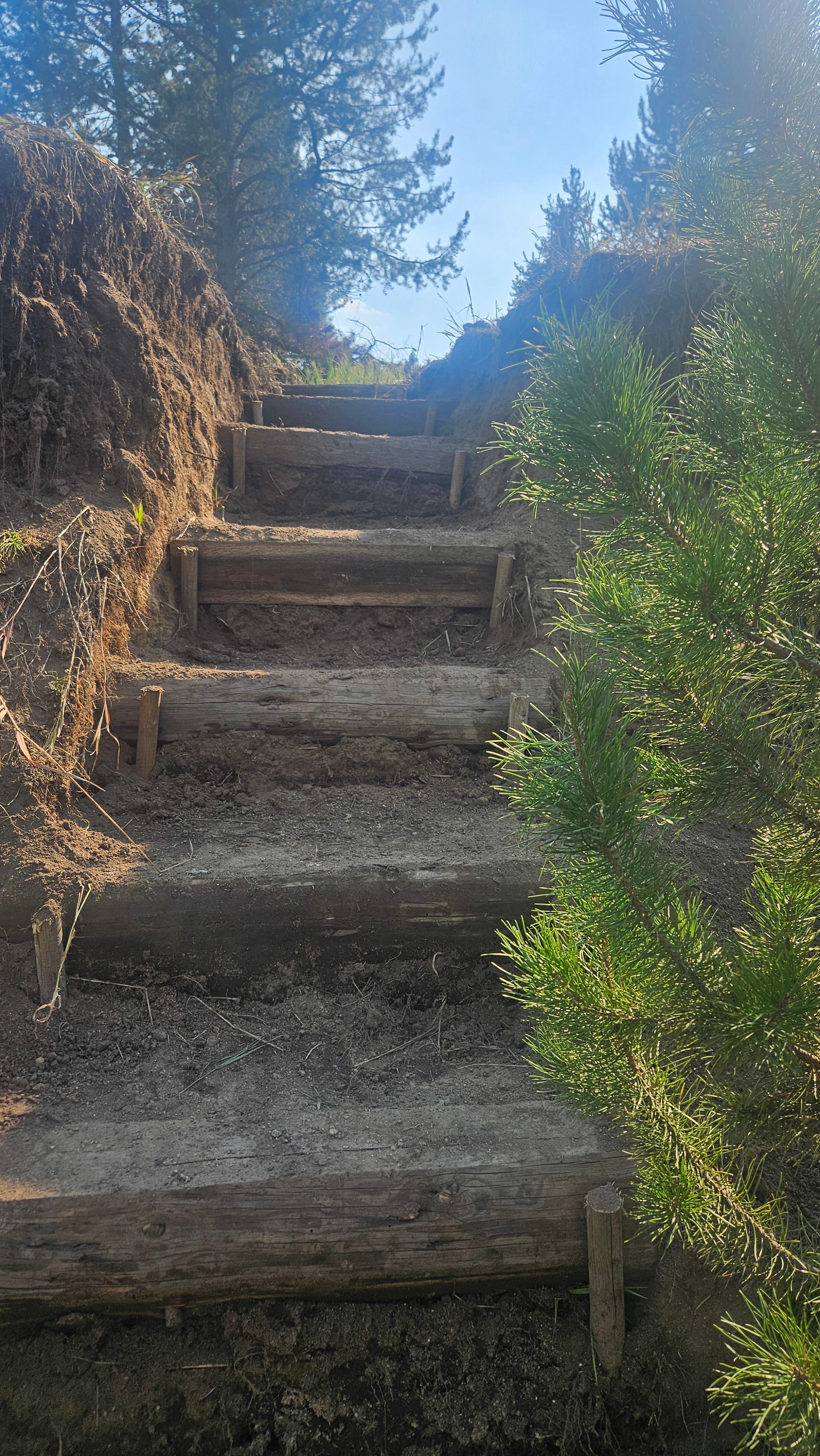 Private stairs leading down from the site to the creek, offering direct access for relaxing by the water, enjoying nature, and letting pets explore under supervision.