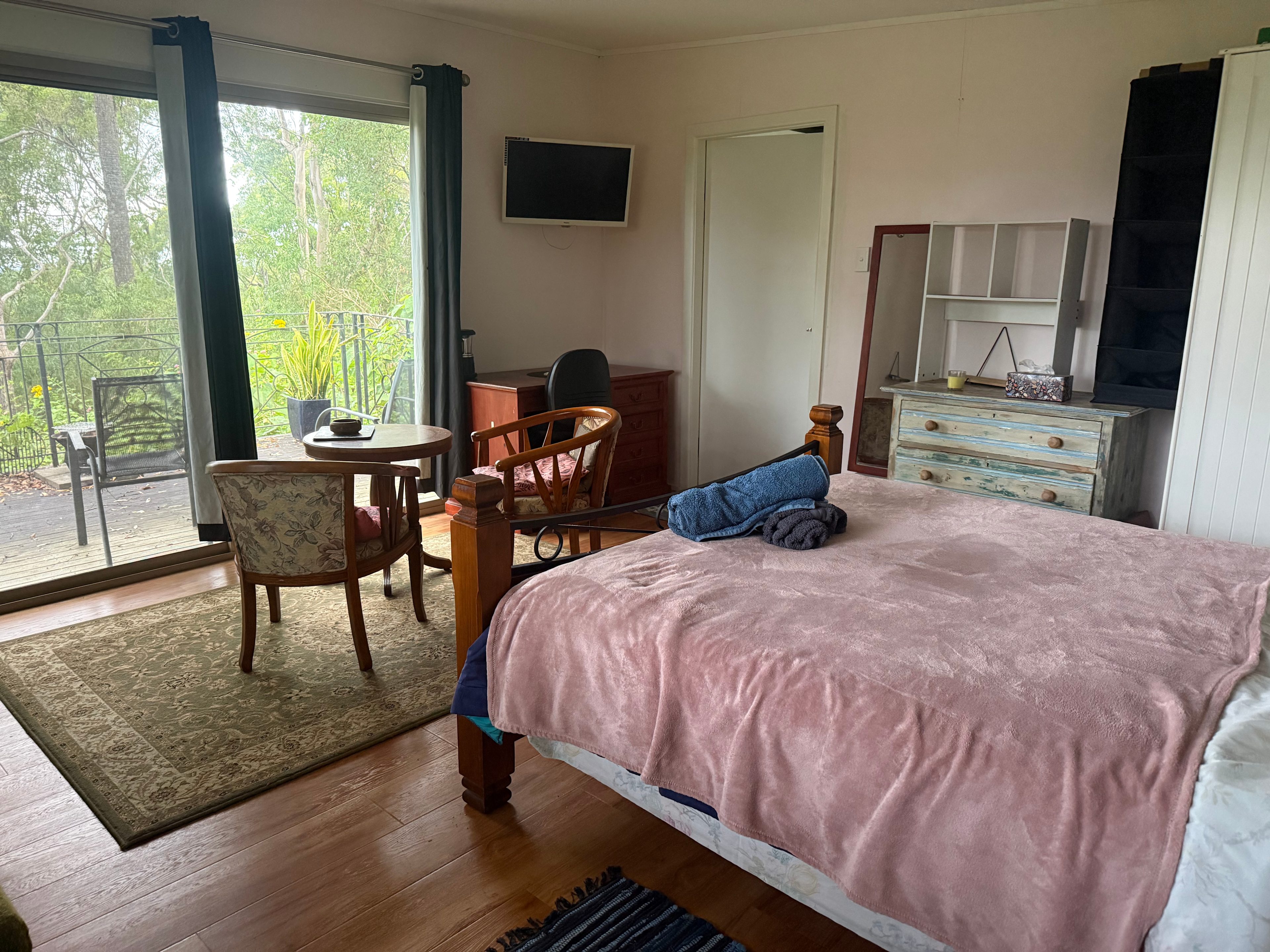 Comfy queen-size bed in open plan bed-living room.