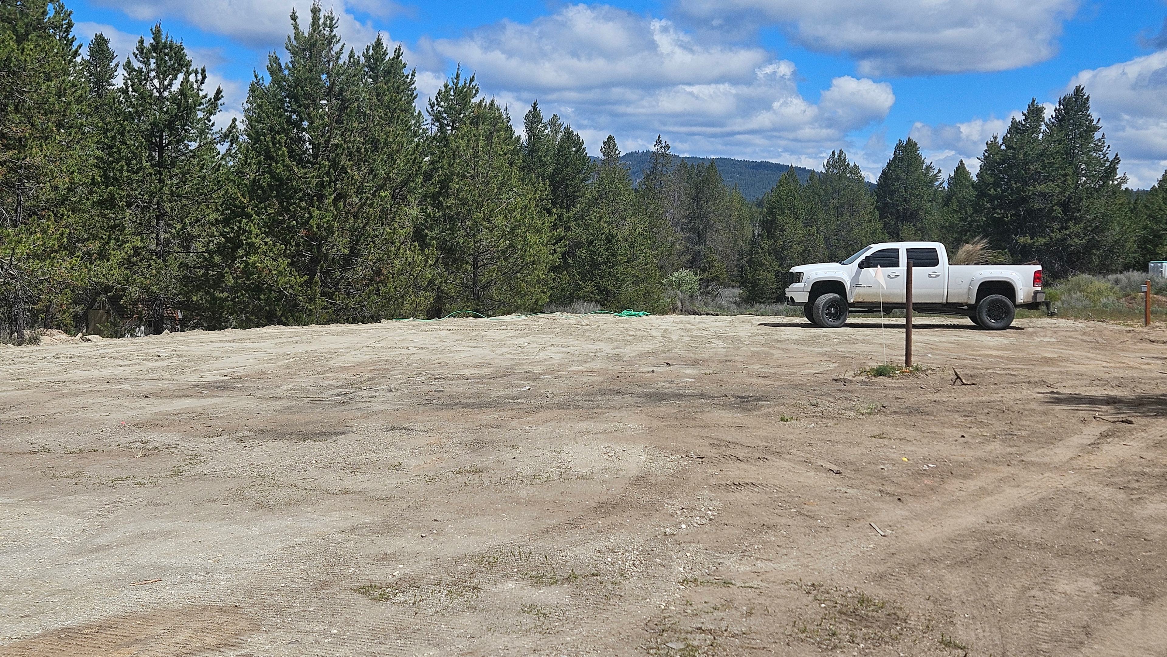 Pole is RV dump site. Electric hook up on left side of truck. Water hookup on right side if truck. Truck is where you park your RV. It overlooks the creek. 