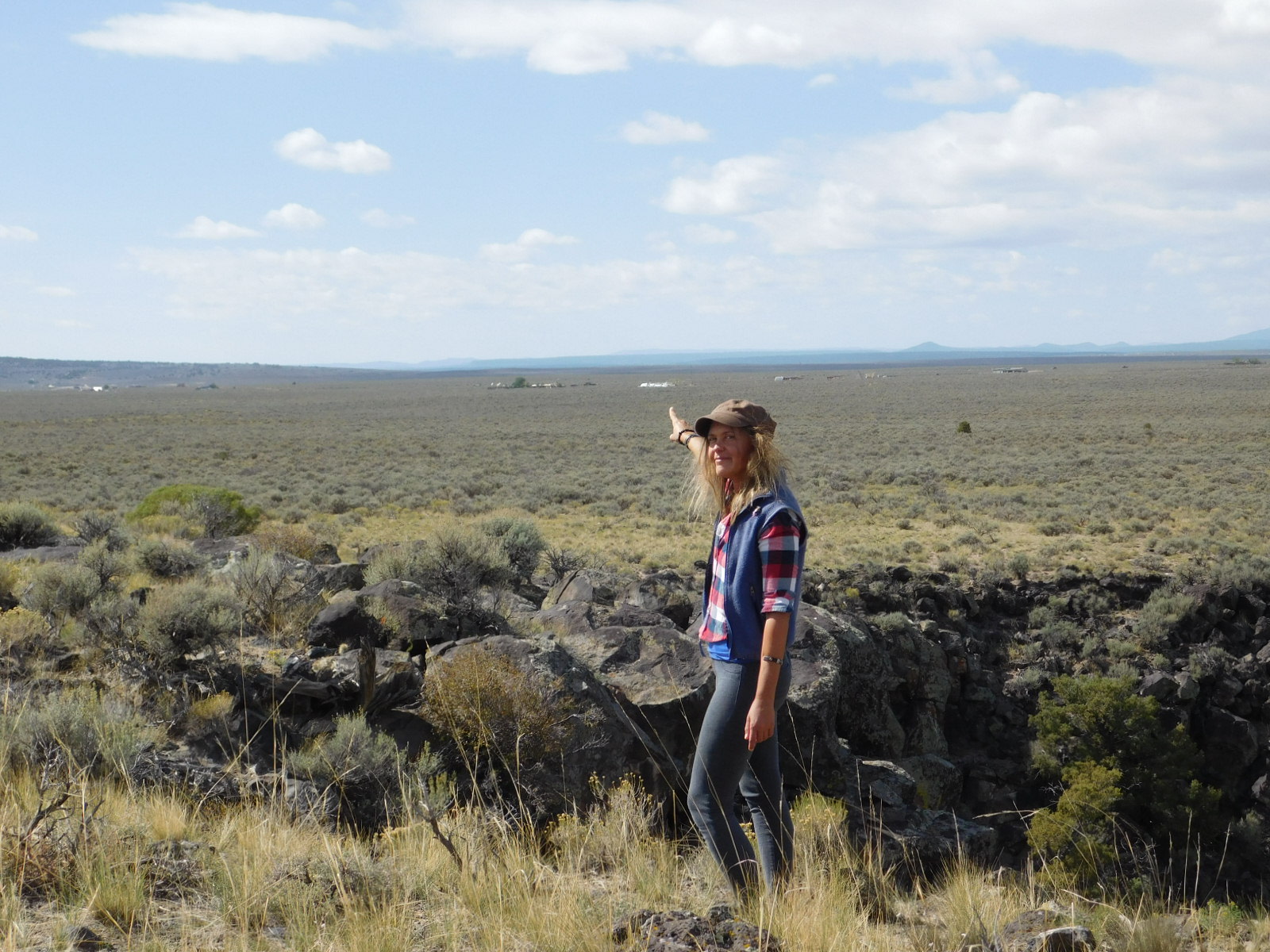 Your Host, Olga Noll , pointing to Stargate from the 15 minute walk through BLM land to the West Rim of the Rio Grande Gorge.
