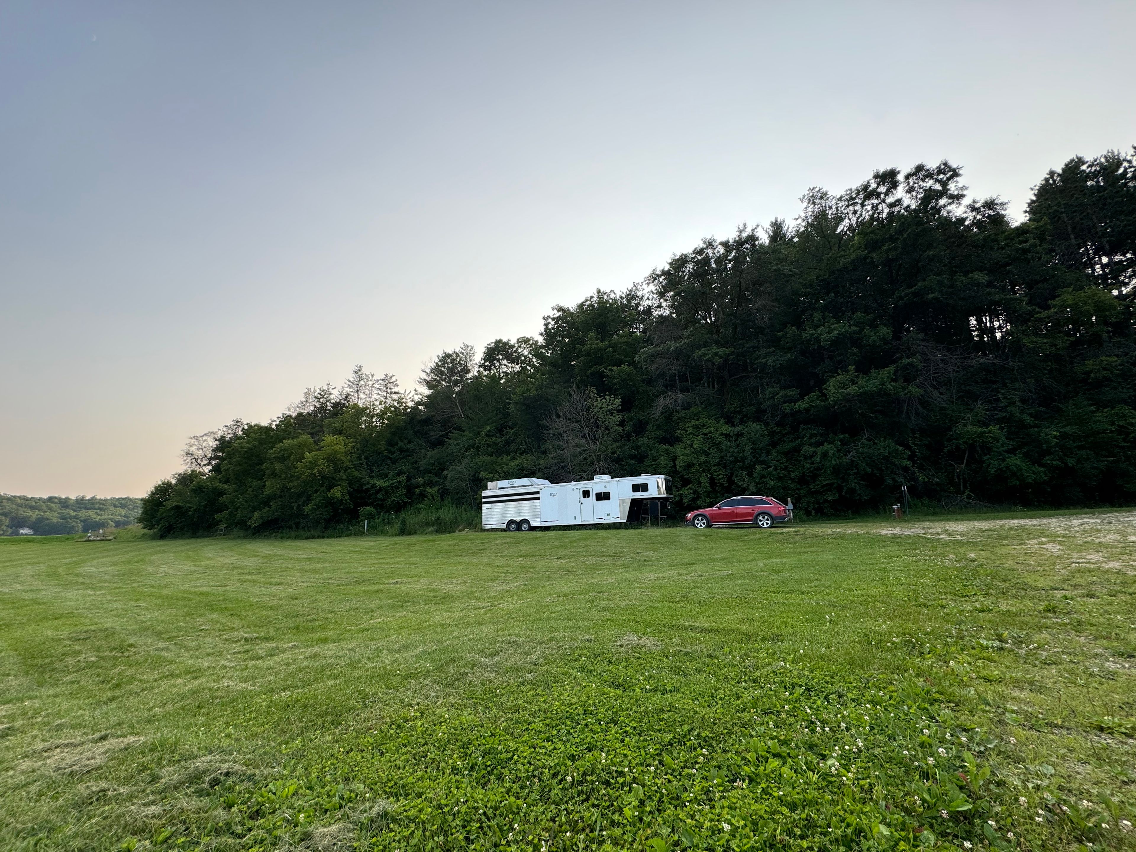 View of the dedicated RV pad setting against the wooded hillside. 