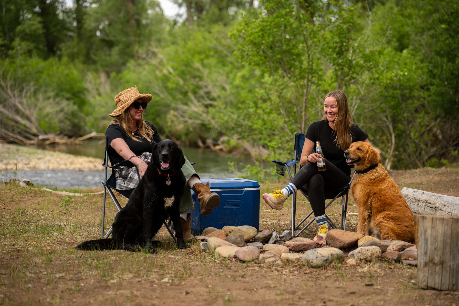 Sitting around our riverside camp with the doggos 