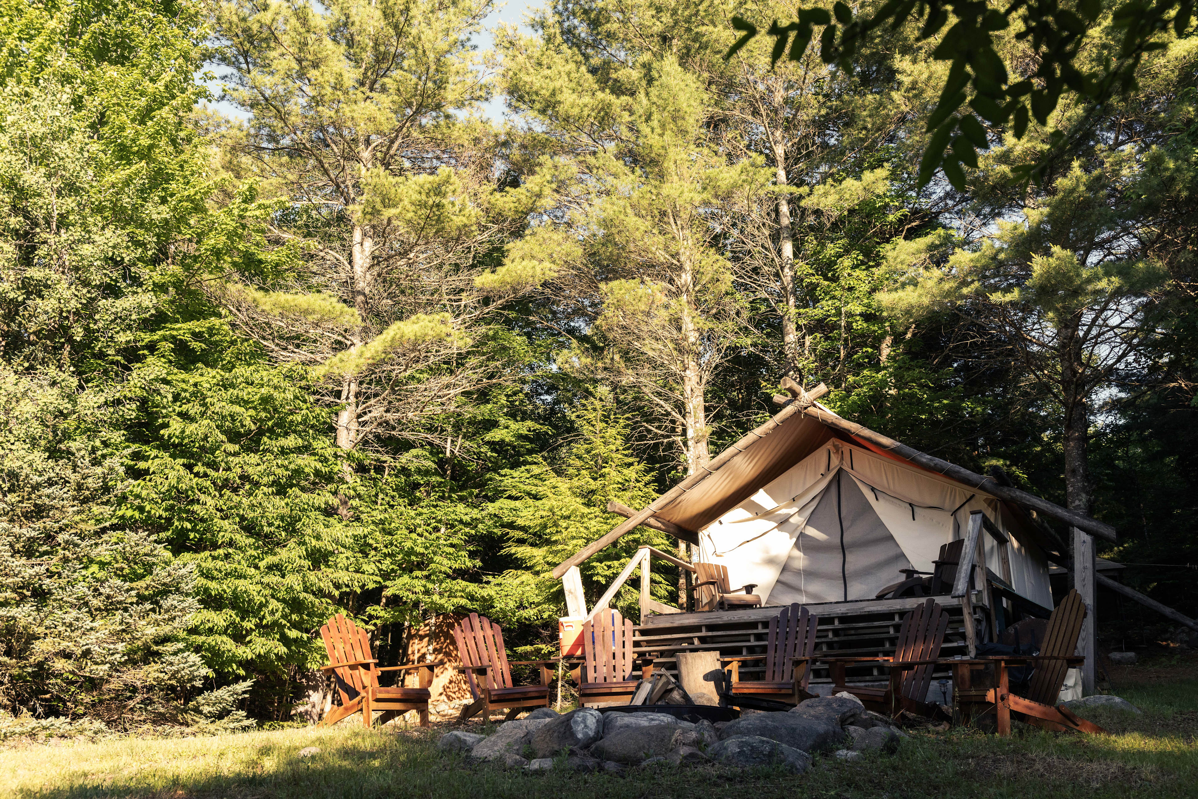 The glamping tent sits atop a raised deck just a few steps from the camp fire.