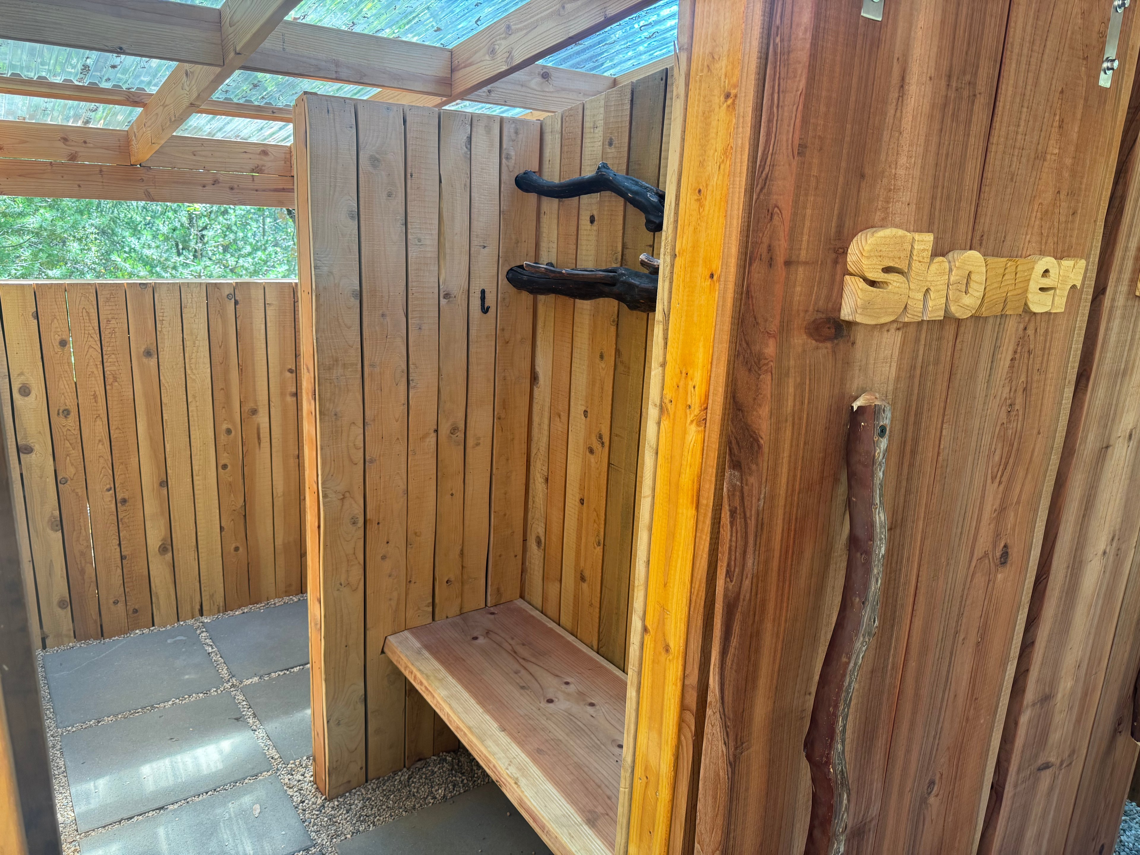 Each shower has a changing room with plenty of hooks to hang your stuff up off the ground.