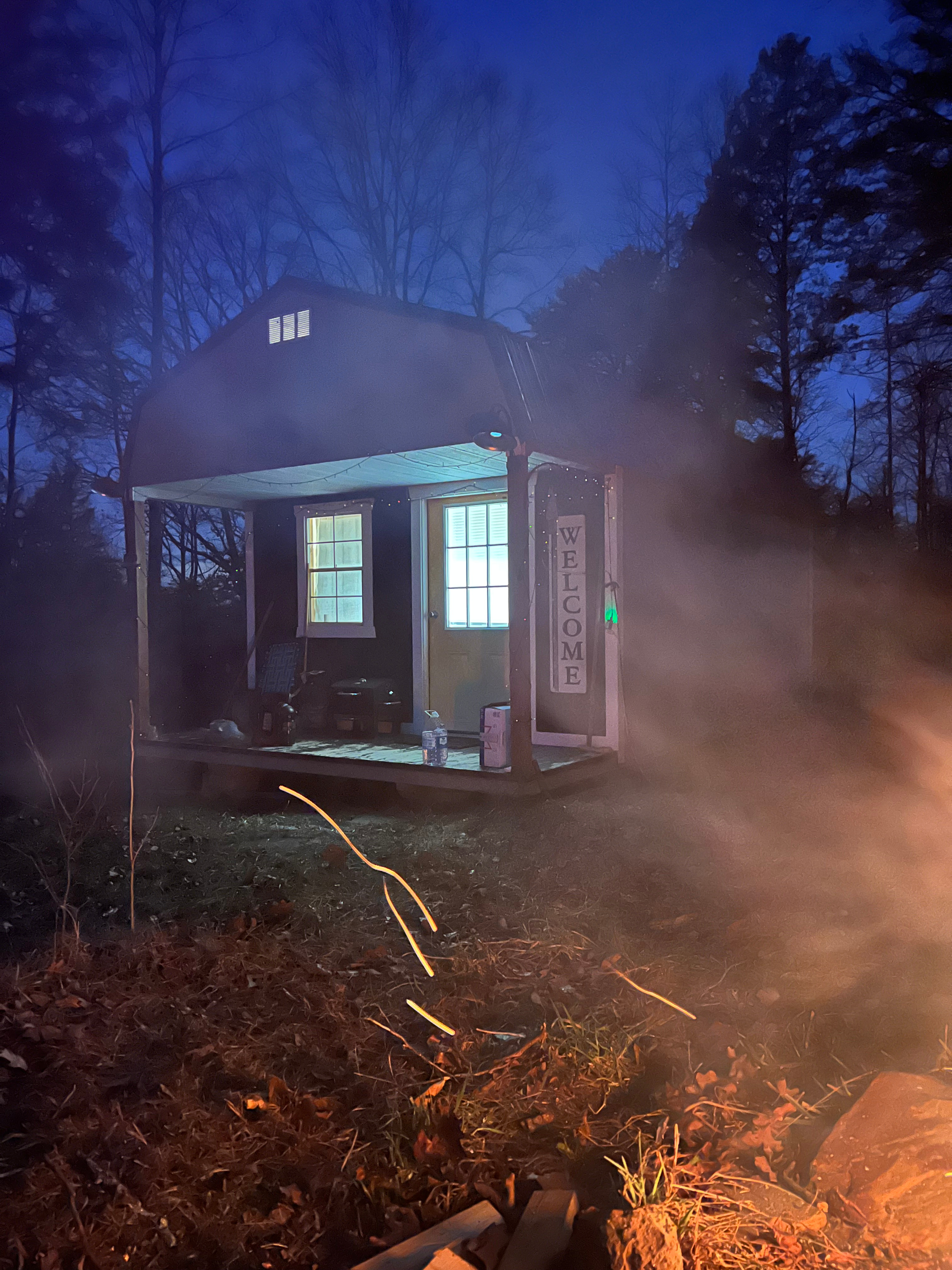 Front view of cabin at dusk from fire pit