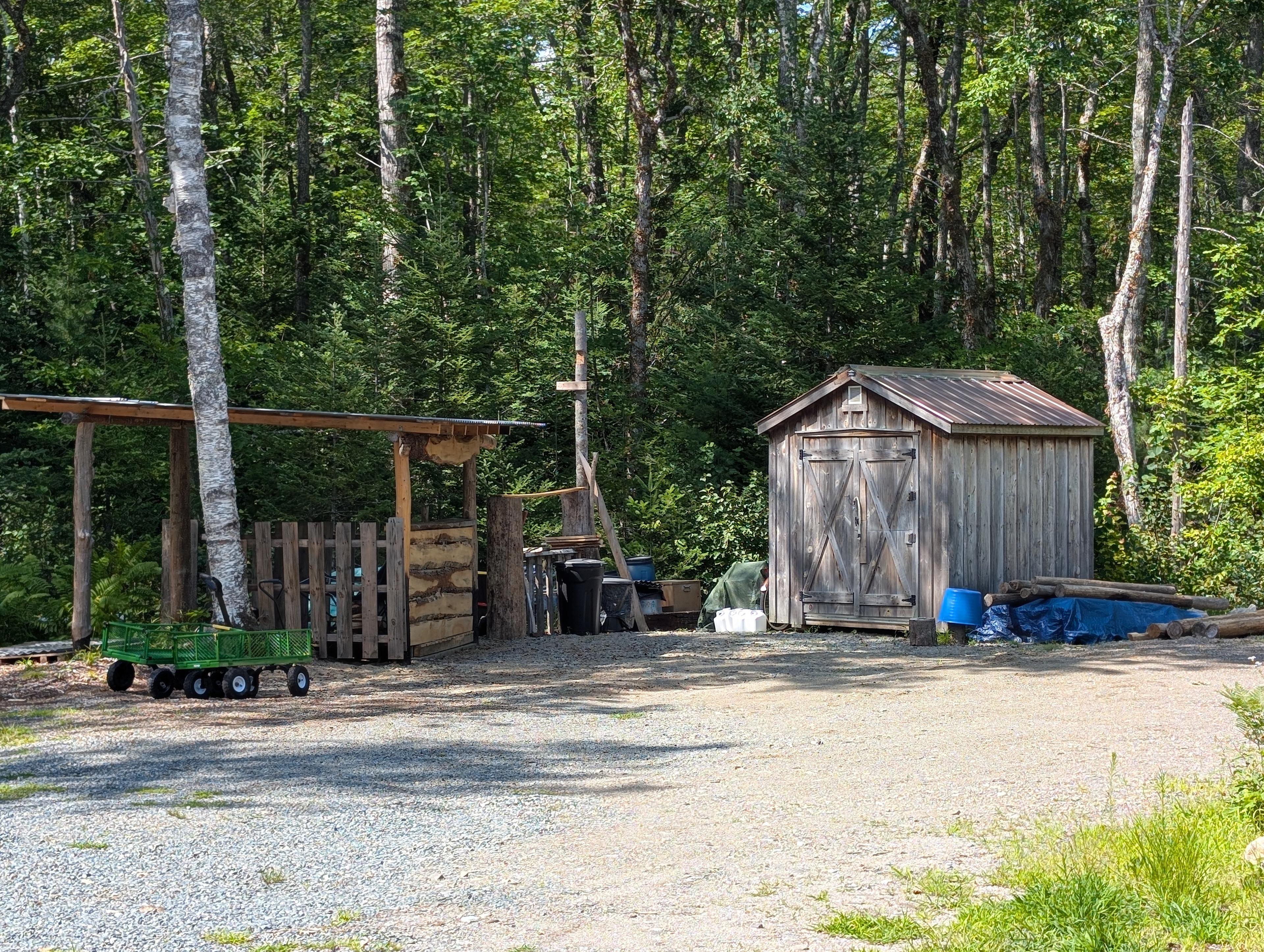 The structure to the left is for car campers to have a fire and hangout. Use this space to park your camping vehicle. Shed will be moved at some point giving you all this space.