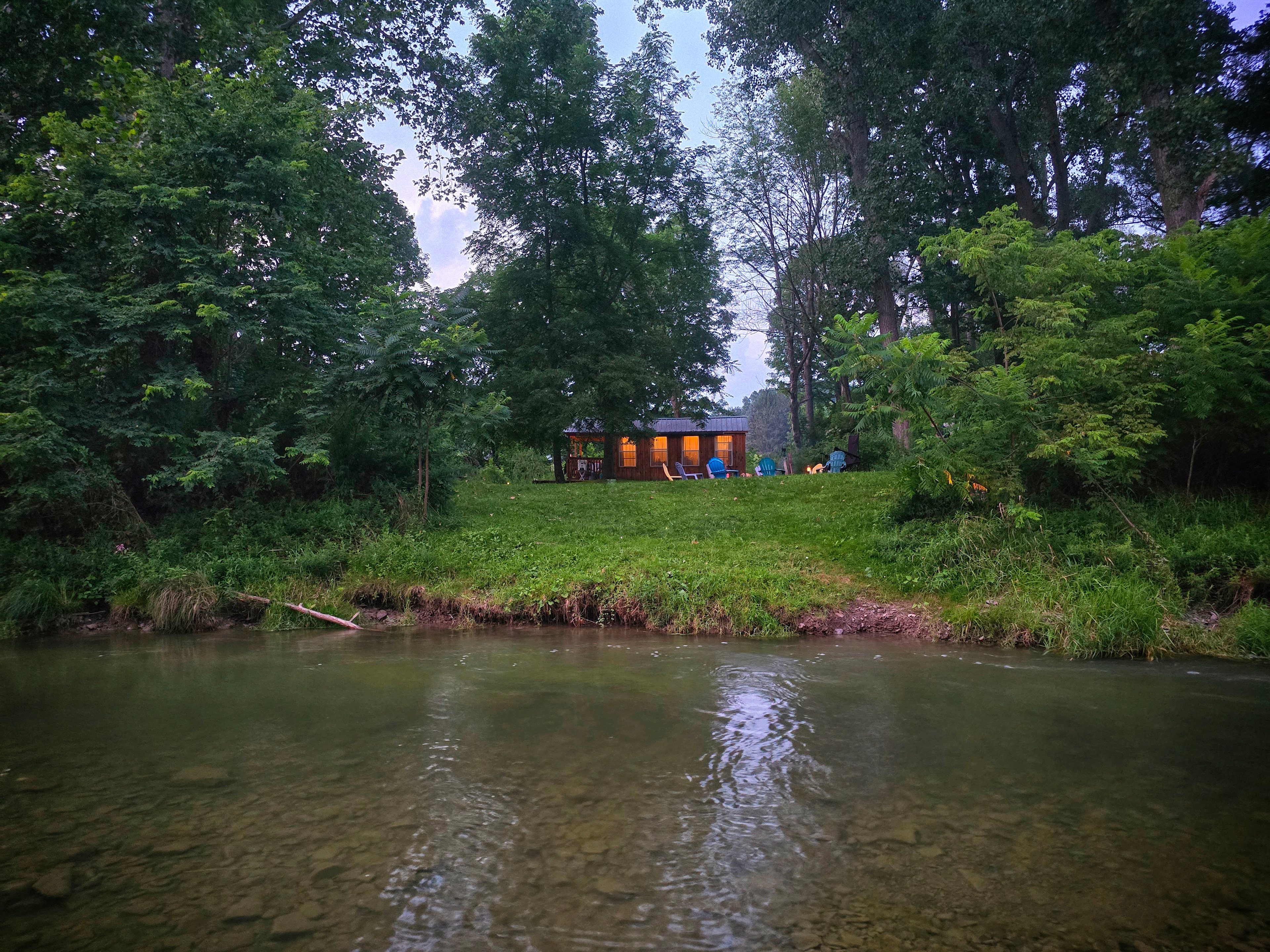 View of cabin from creek summer of 2026. The creek is constantly changing. 
