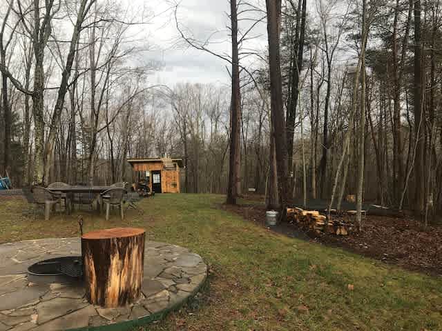 1 acre campsite has a bathhouse with flushing toilet, mini outdoor kitchen, solar outdoor shower, tent pad, table for 8, firepit with grill and horseshoe pit. 