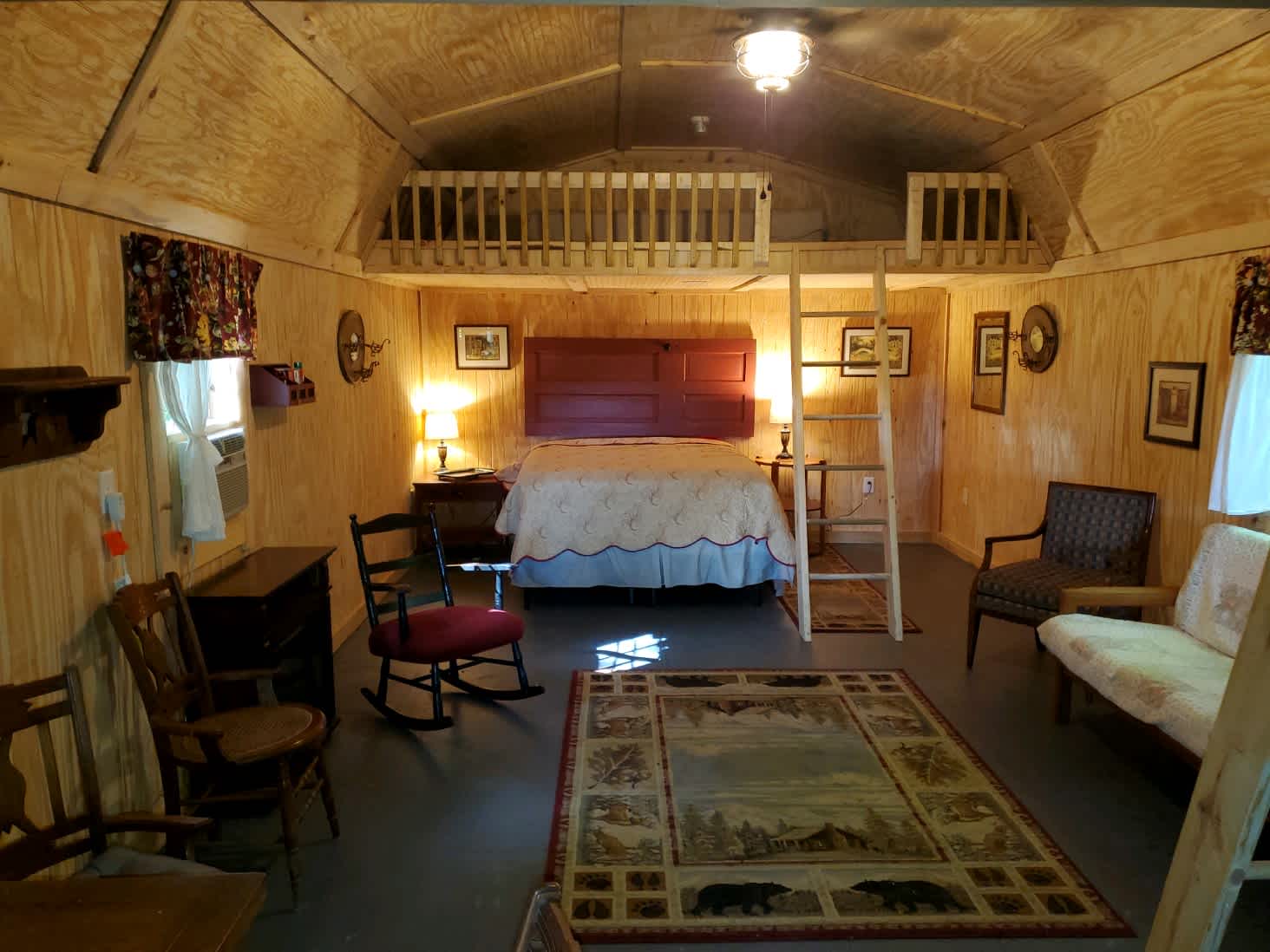 Beautiful rustic and cozy interior of our red cabin. Sleeps 6 with 2 queen and 2 twin beds. Couch, Mini Fridge, and coffee maker make this the most co