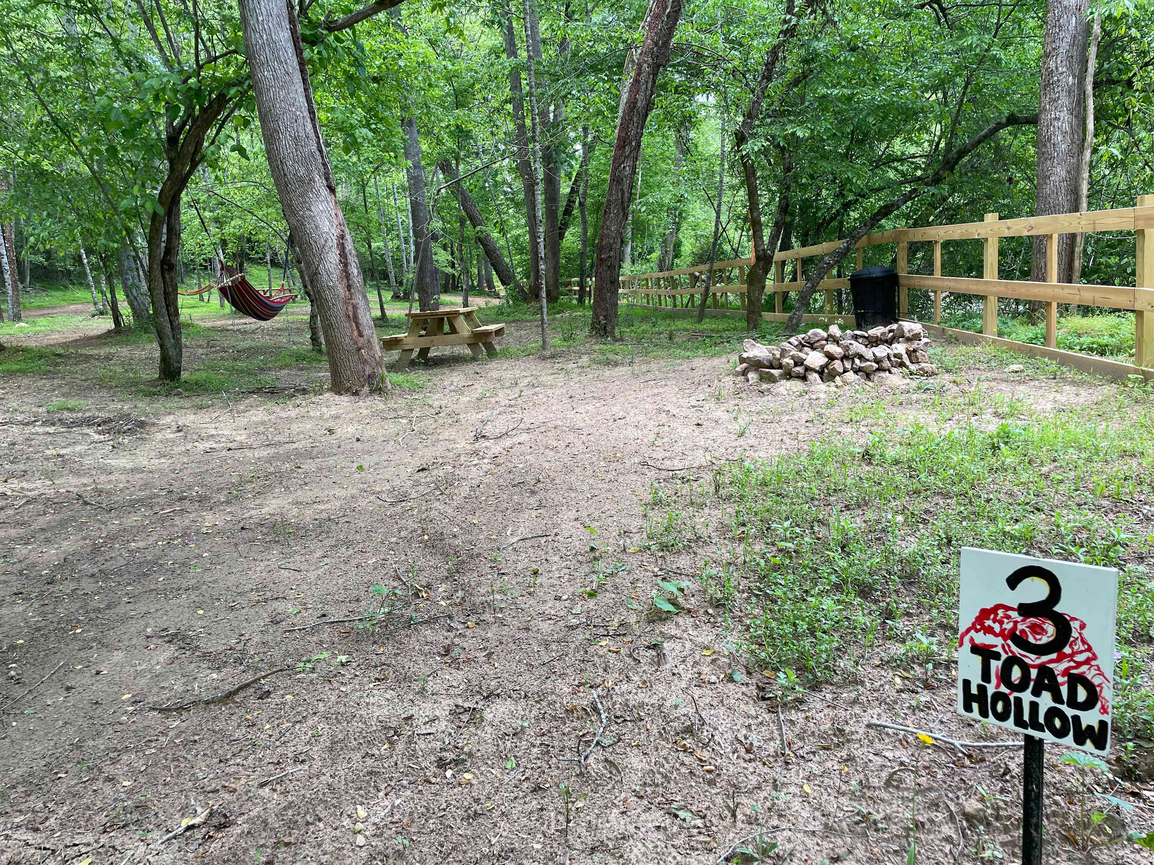 Toad Hollow is spacious, shaded, and on the riverfront with hammock, picnic table, trash receptacle and firepit. Parking is onsite