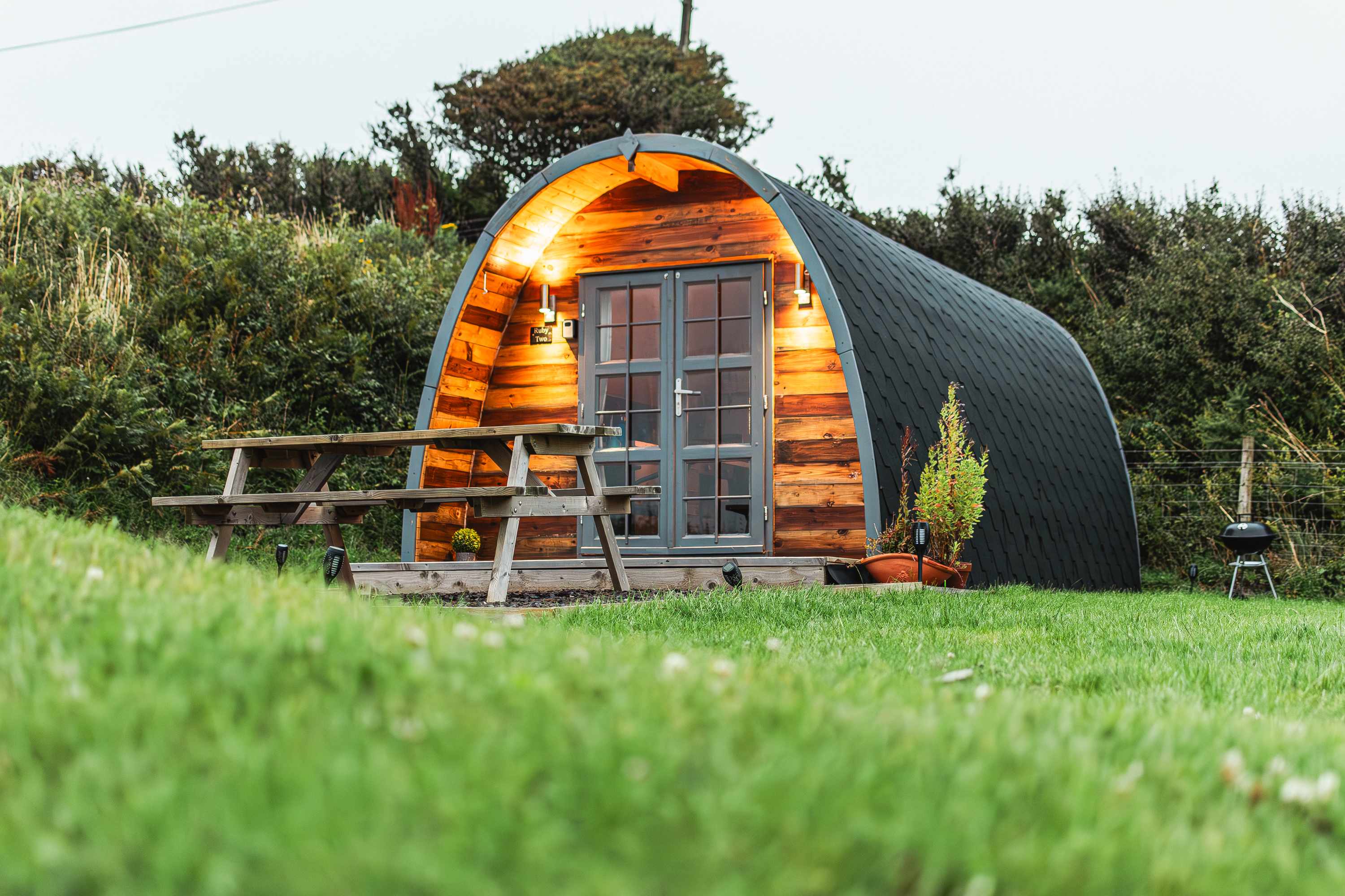 Ambient lighting bathing the pod with a warm glow in the evening