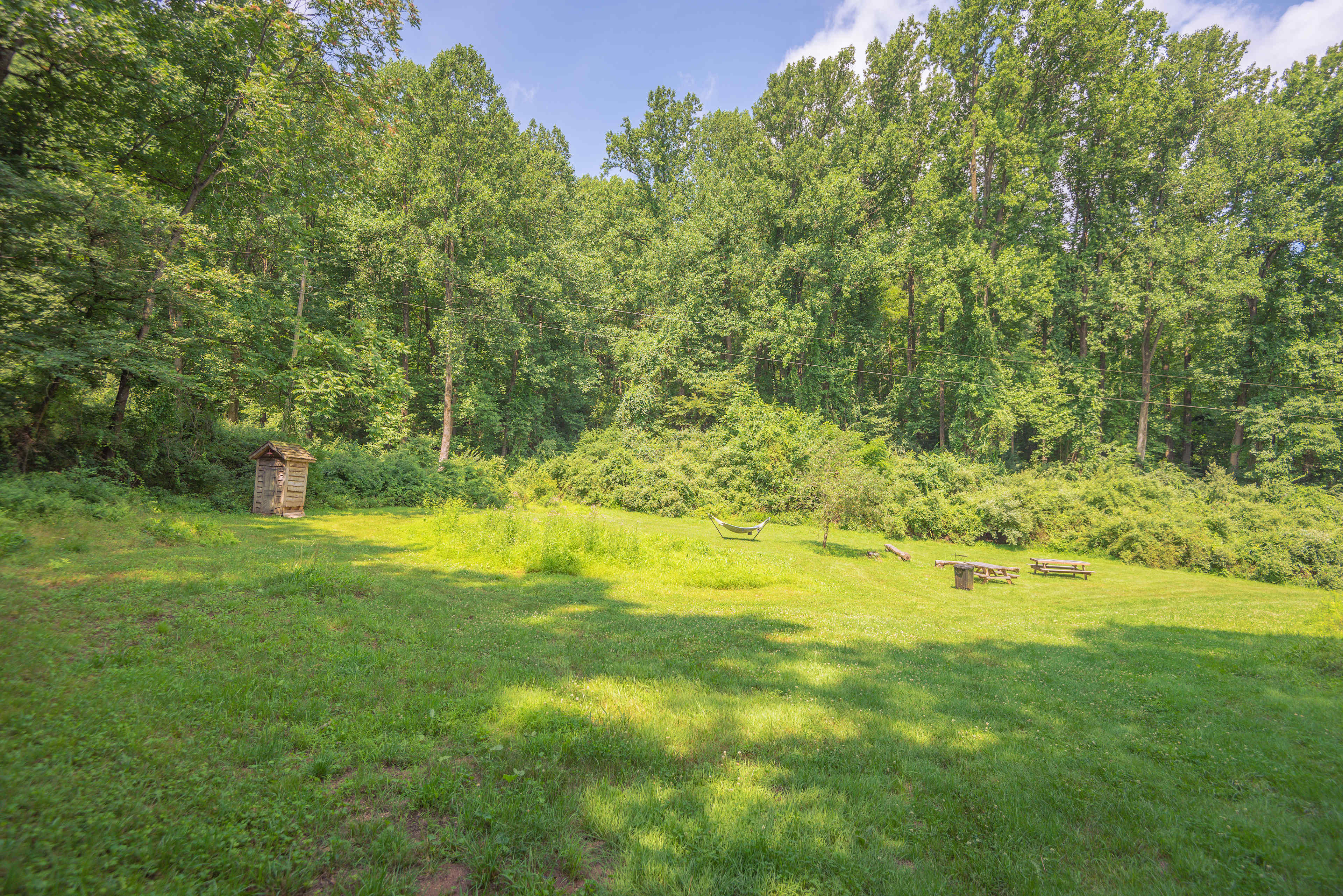 Site #2 is a huge site with a ton of space available for a large group. It has a private outhouse, hammock, firepit, and entrance into the woods for hiking.