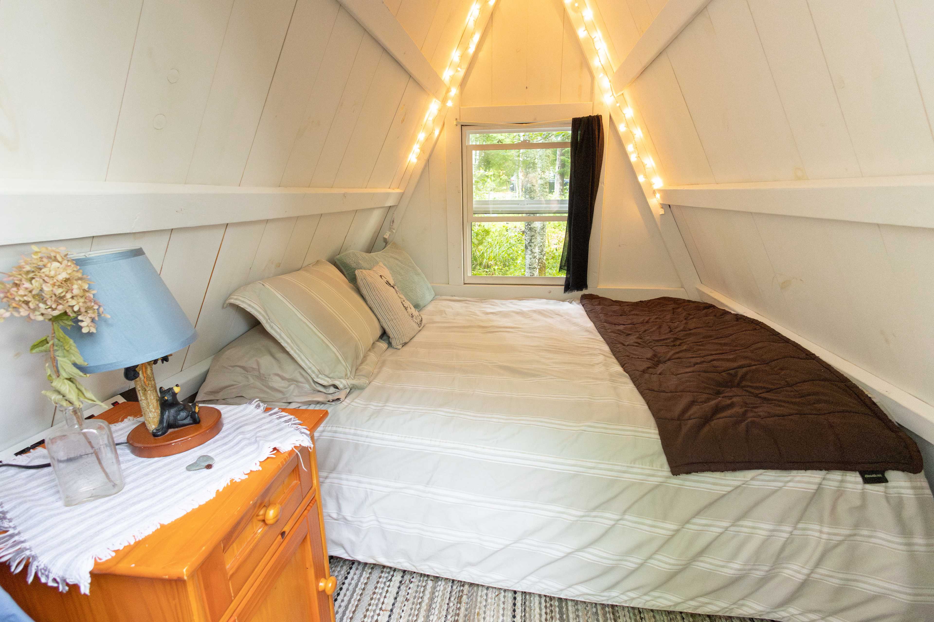 Inside the cabin there is a comfy bed, lights, electricity, hooks, and a nightstand. 