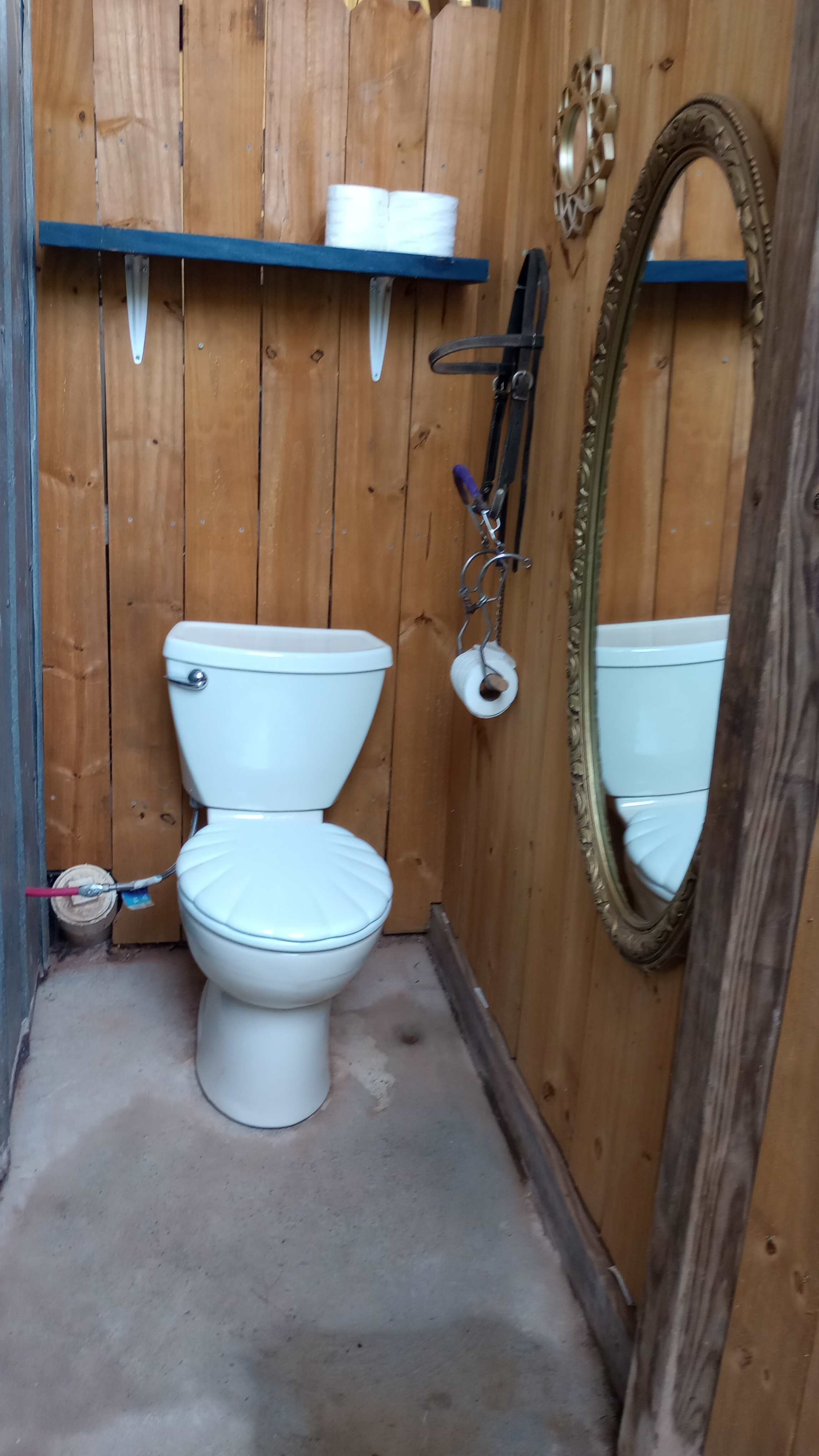 Bath is located at the bottom of the stairs leading to the loft. 