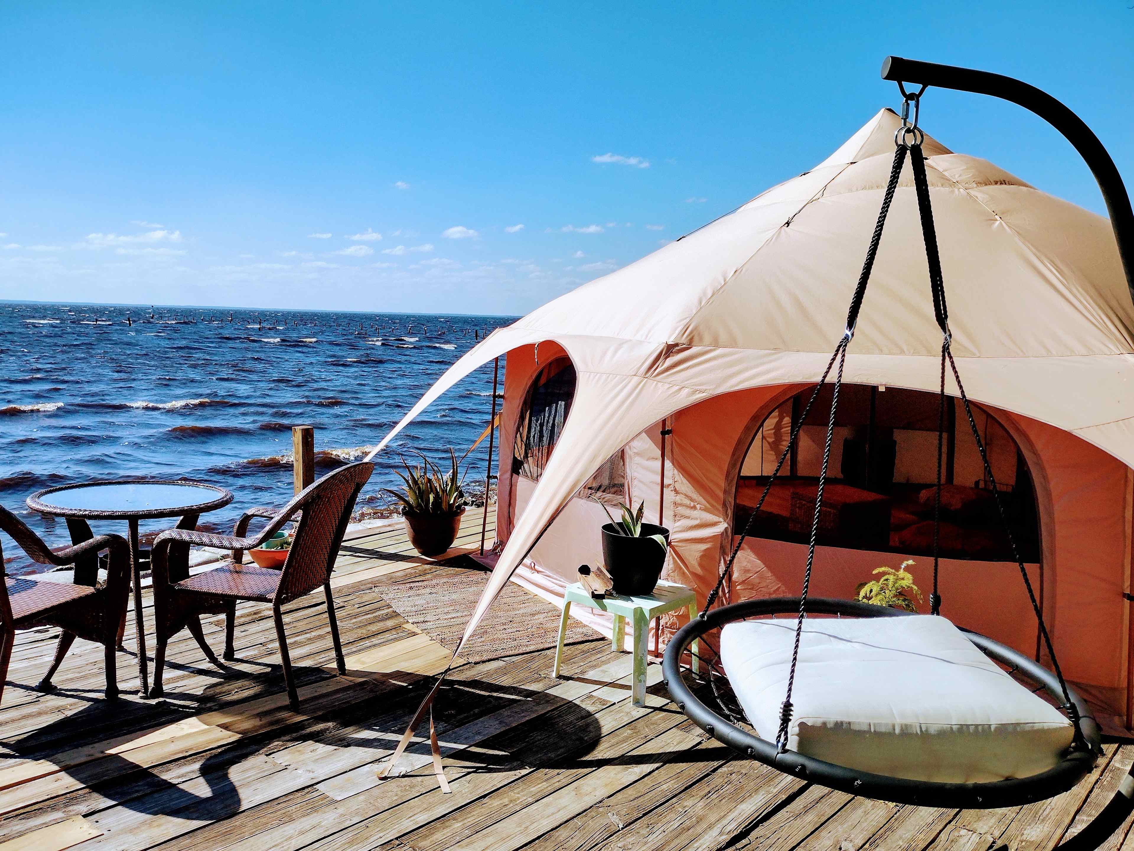 Romantic Waterfront Glamping Tent with room to relax and enjoy dreaming to the serene sounds of nature after a beautiful sunset evening. We are clothing optional so you can loose your tan lines and 420 friendly so you can loose your stress and Relax in Nature at Runaway Bay Lodge.