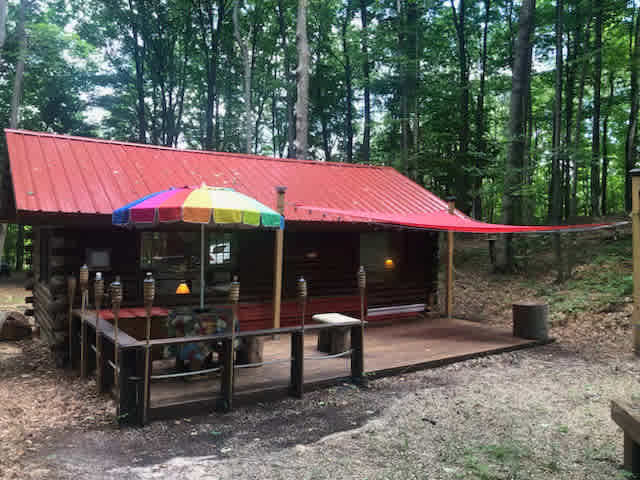 Backside of the bunkhouse with firepit beyond