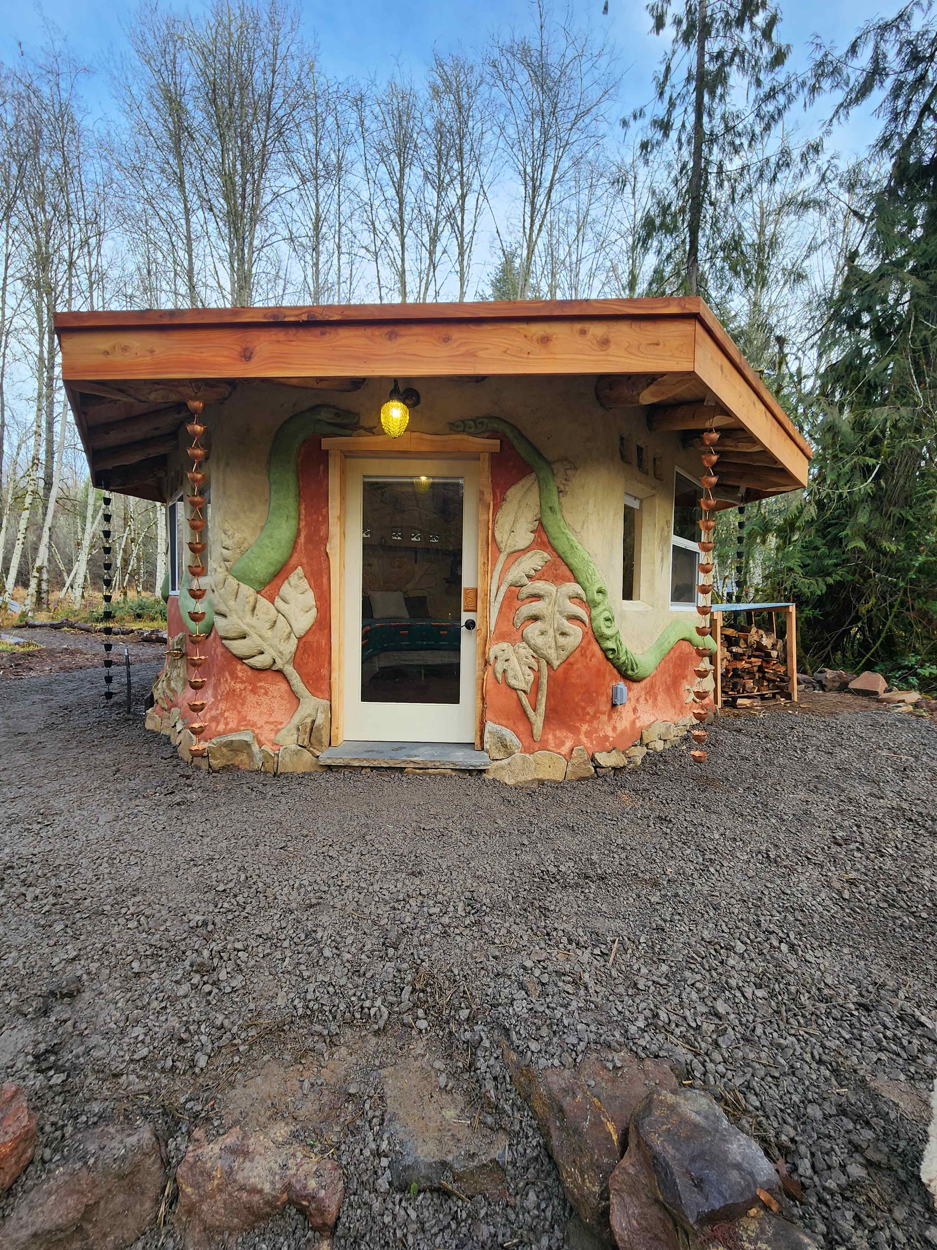 Our beautiful cob house showcasing the incredible artist who helped build this magical cabin.