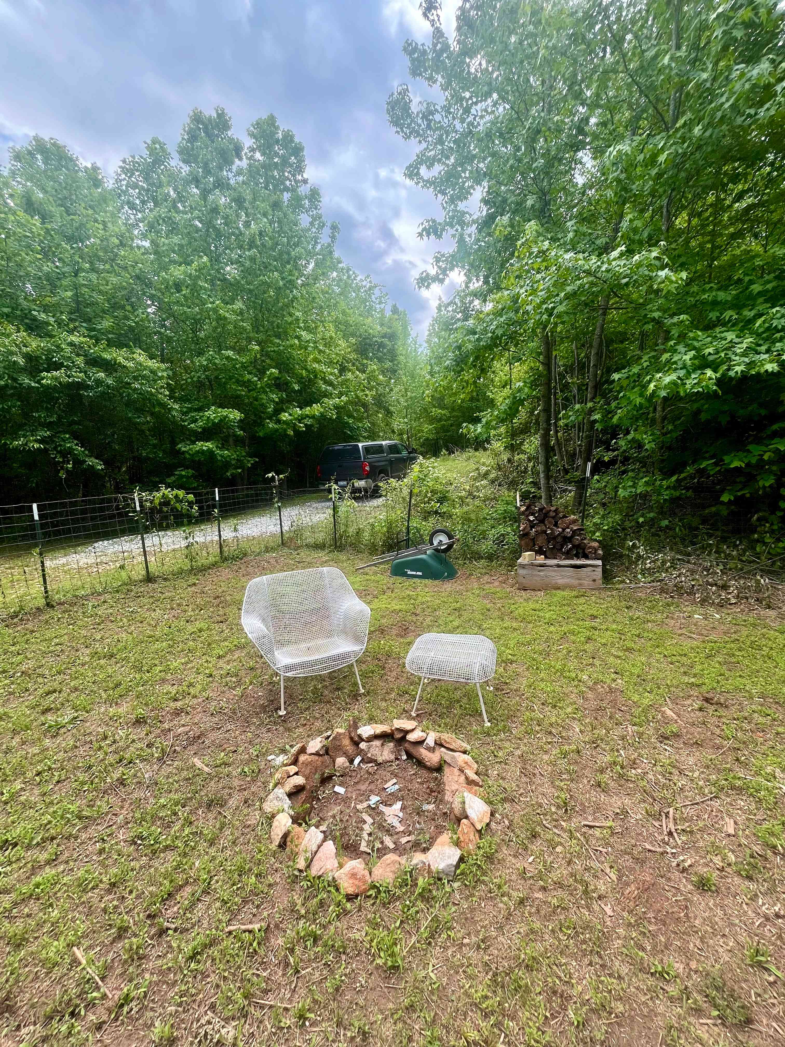 Rock lined fire pit with a chair and side table/stool!