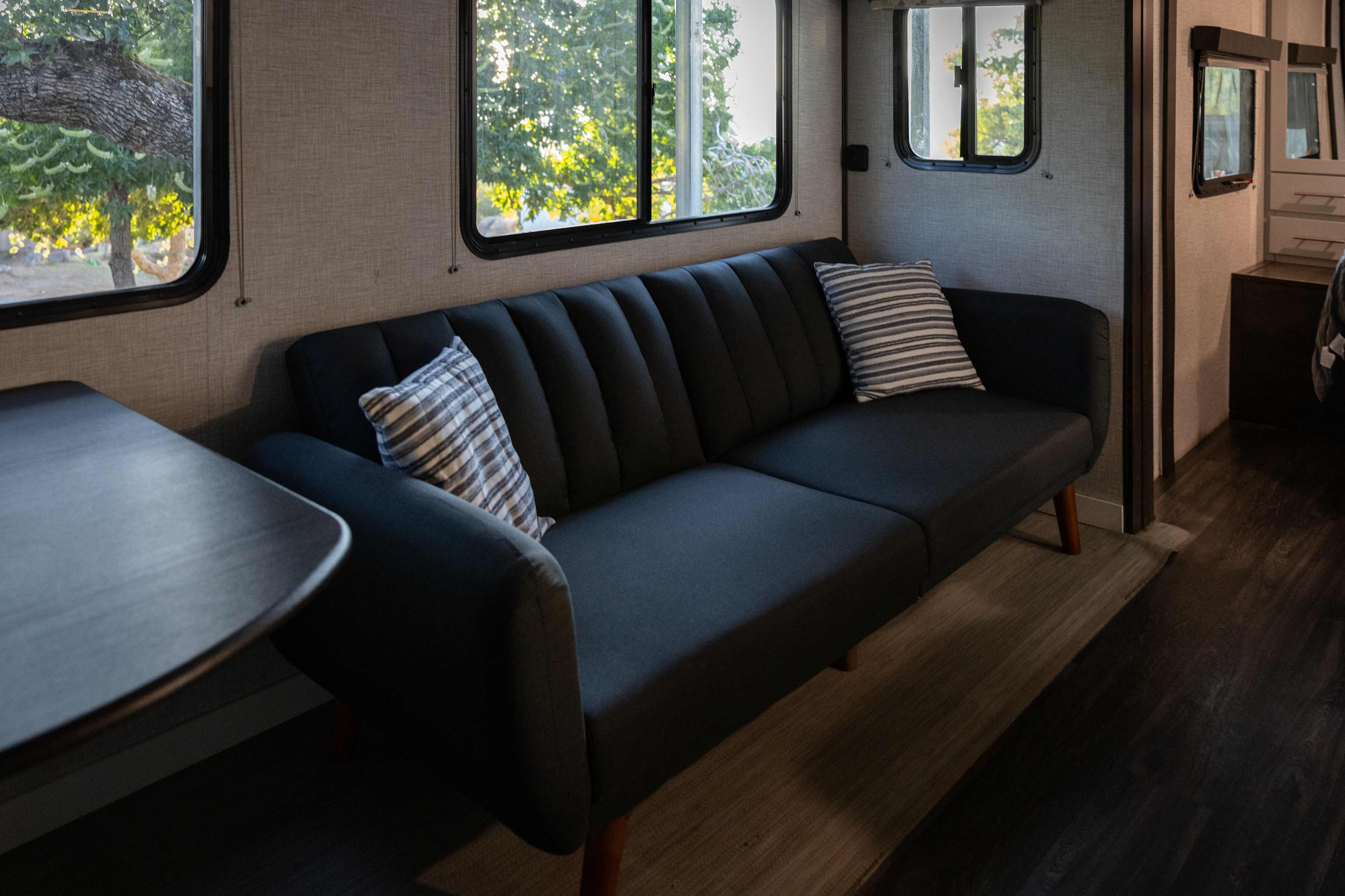 Comfy couch in the living space is perfect for watching tv or reading