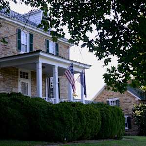 The beautiful 1812 farmstead stands tall among the acres of pastures surrounding it.