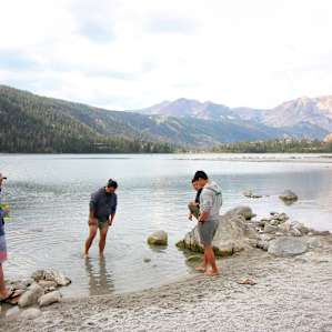 Dipping our feet in the ice cold water. The beach is made up of small rocks, not sand. The water is very shallow for at least 100ft out.