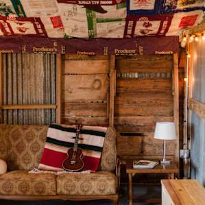 Cozy lounge area with reading material in the front of the barn