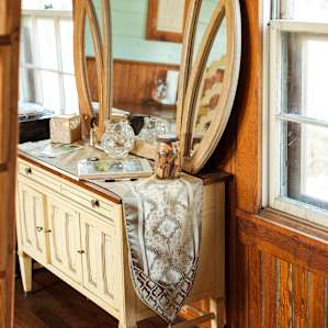 The vanity holds towels, ground coffee, and filters.