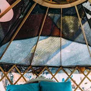 The yurt is made out of old billboard signs, making each piece uniquely patterned and colored.