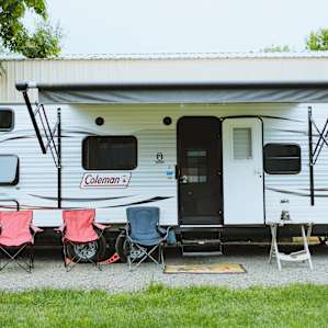 The exterior of the camper. Complete with chairs for friends and an awning to enjoy any kind of weather.