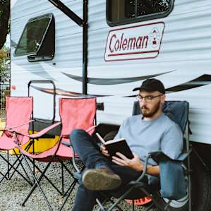 The exterior of the camper. Complete with chairs for friends and an awning to enjoy any kind of weather.
