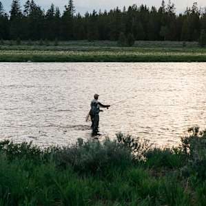 Fisherman in river nearby