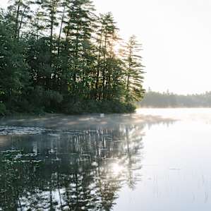 Sunrise over the lake with the fog rolling out