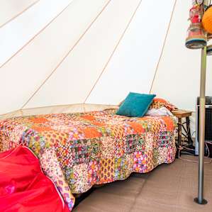 This tent comes with everything you could want: beds, beanbag chairs, lanterns, power, a fan and A/C.
