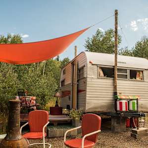 Campy and the shaded seating area, overlooking the forest and outdoor fireplace.