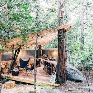 The kitchen and lounging area is so unique, built around and from trees on the property.