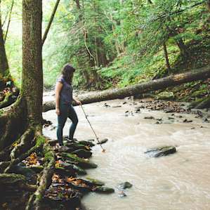 The water isn't too deep... I'd recommend water shoes if you want to attempt to cross to the other side.