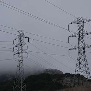 Big power lines up the dirt road that buzz.