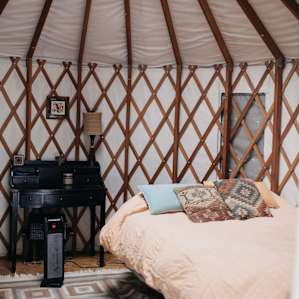 Nice queen bed next to a desk and chair
