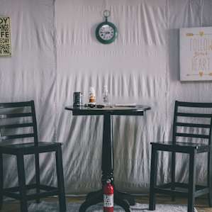 A couple chairs and a table to enjoy the company of another