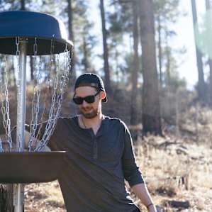 One of several disc golf baskets set up in the forest