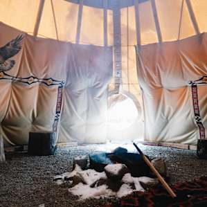 The fire pit inside the tipi was very useful for keeping warm and dry as well as cooking. The white fluffy stuff around the fire pit is snow that fell from the air vent at the top (which also lets smoke out)
