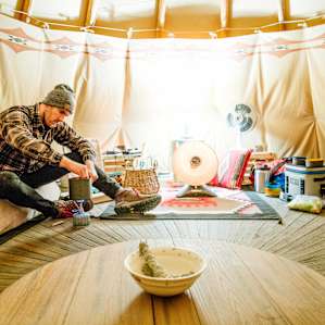 Dan working on dinner inside the Tipi! :)