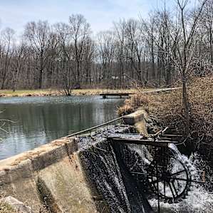 Cool water wheel by the pond's dam