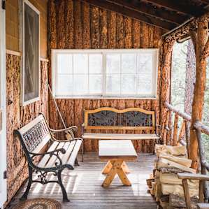 The quaint porch with lots of seating to sip coffee and enjoy the magical hummingbirds that frequent the feeder.