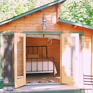 The quaint cabin that rests in 20 acres of beautiful lush property