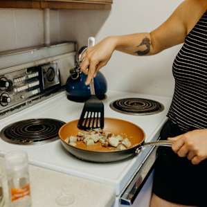 cooking breakfast in the communal kitchen.