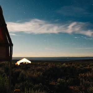Neighbouring tent glowing at dusk.